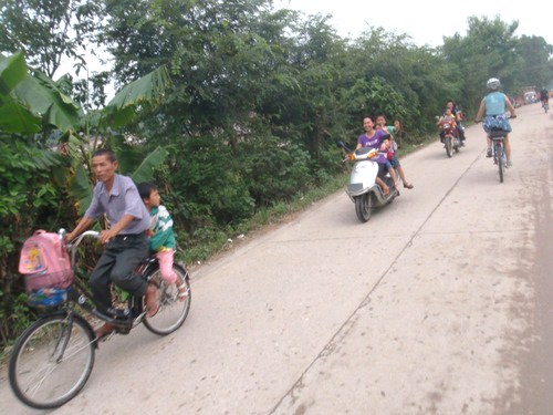 Parents and kids on bicycles and scooters.